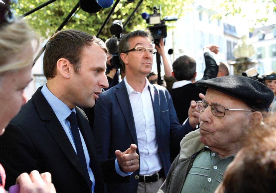 EMMANUEL MACRON talks with residents during a presidential campaign visit yesterday in Bagneres de Bigorre, France.