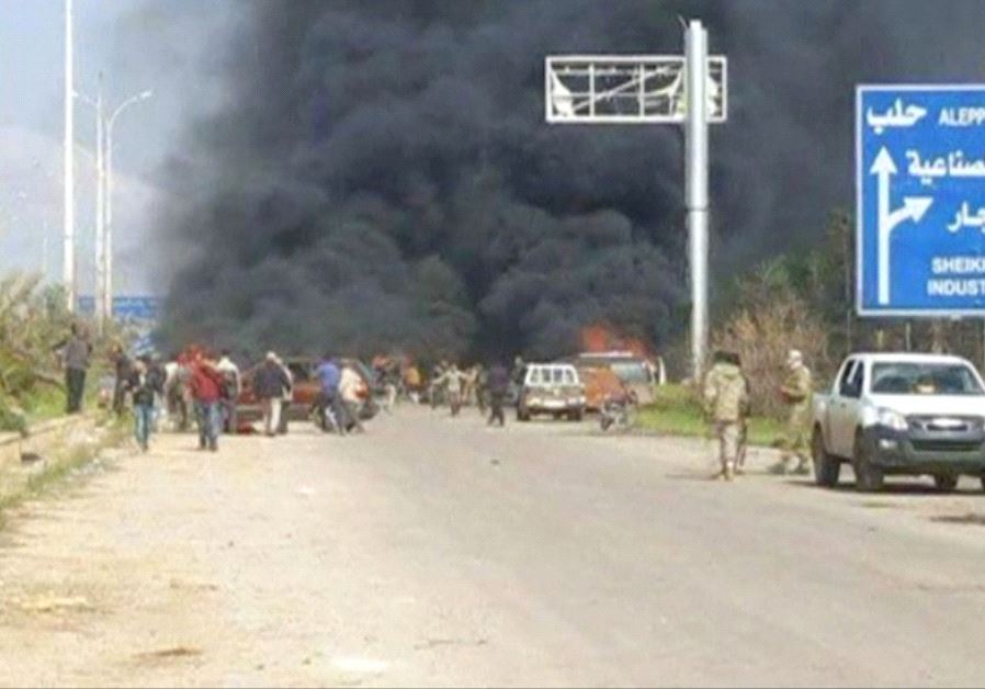 Still image shows a cloud of black smoke rising from vehicles in the distance in what is said to be Aleppo's outskirts, Syria 