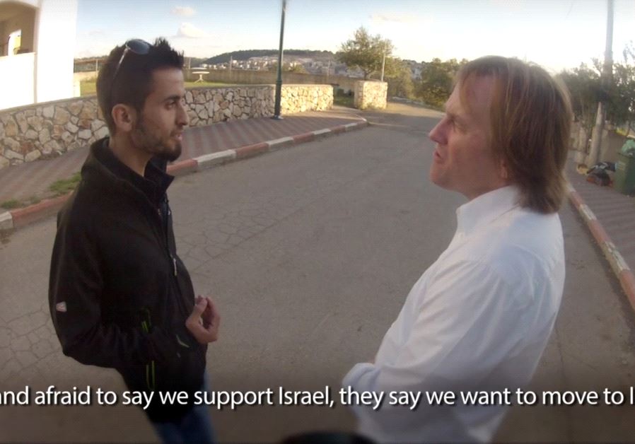 A screenshot from the film 'Boycott This!' showing comedian Brad Stine speaking with a Palestinian in the West Bank. (PTJN)