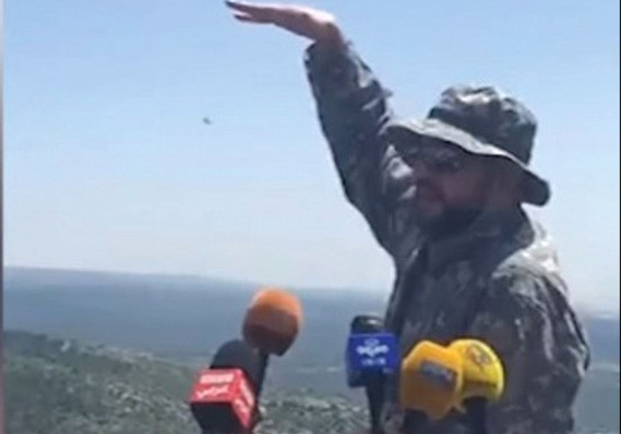 A HEZBOLLAH FIGHTER conducts a media tour of the Lebanese border with Israel yesterday