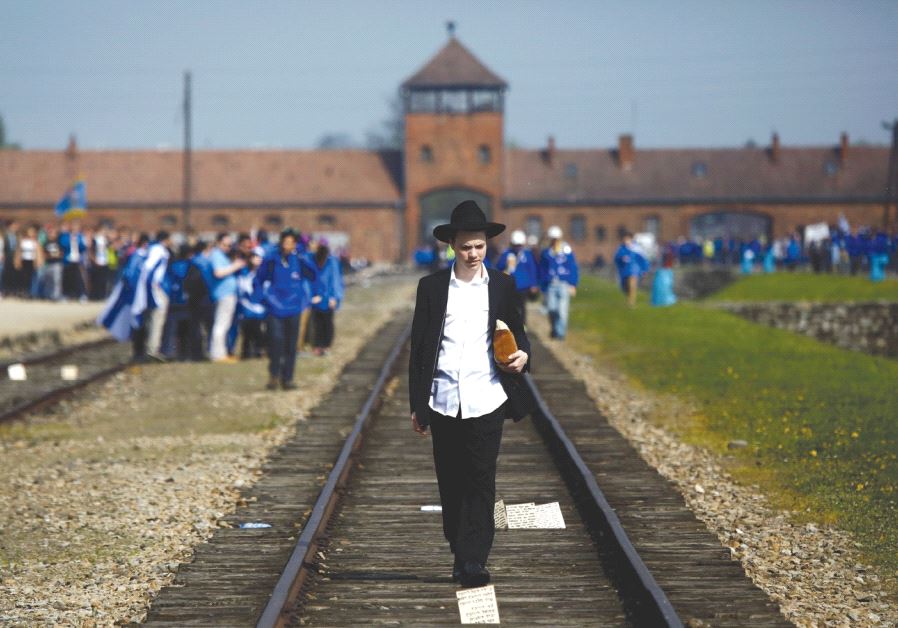 A man walks on the railway tracks in the former Nazi death camp of Auschwitz-Birkenau