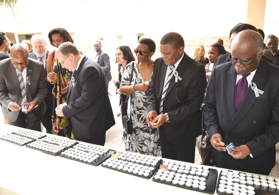 Attendees light candles at an event on April 30, 2017 at Kibbutz Tel Yitzhak marking the 1994 genocide in which 800,000 Tutsis were killed in Rwanda