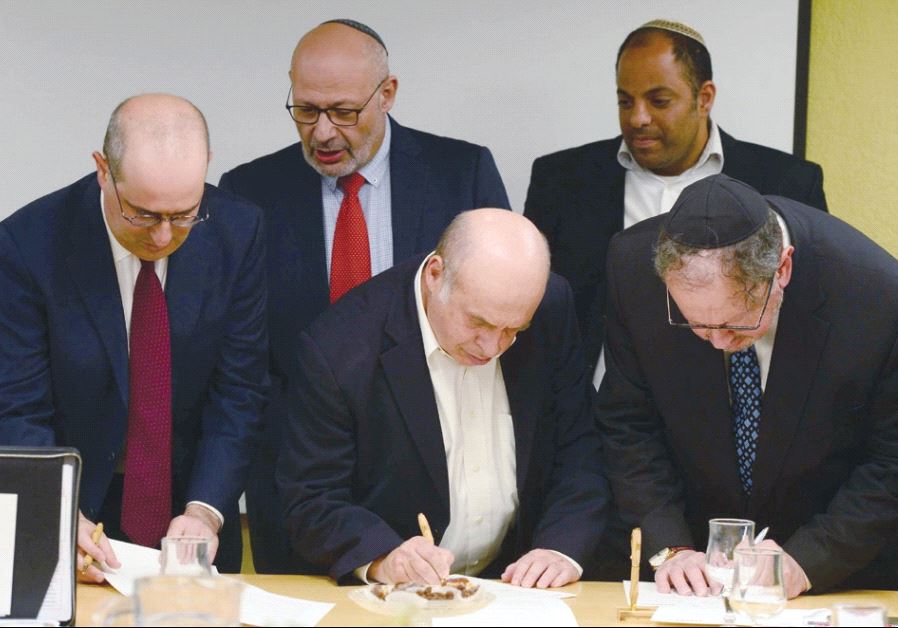 WORLD JEWISH Restitution Organization co-chairs Avraham Biderman (front right to left) and Natan Sharansky sign a declaration of intent for the restitution of Holocaust-era assets at the President’s Residence