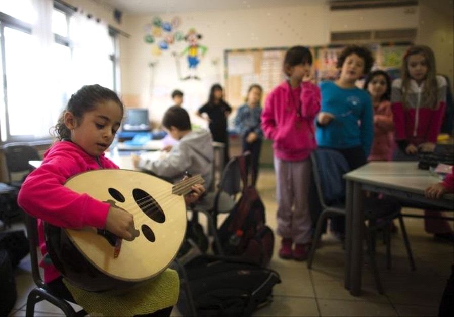 Mirvat, a second grade school girl, practices her oud at the Hand in Hand Arab Jewish bilingual school in Jerusalem.