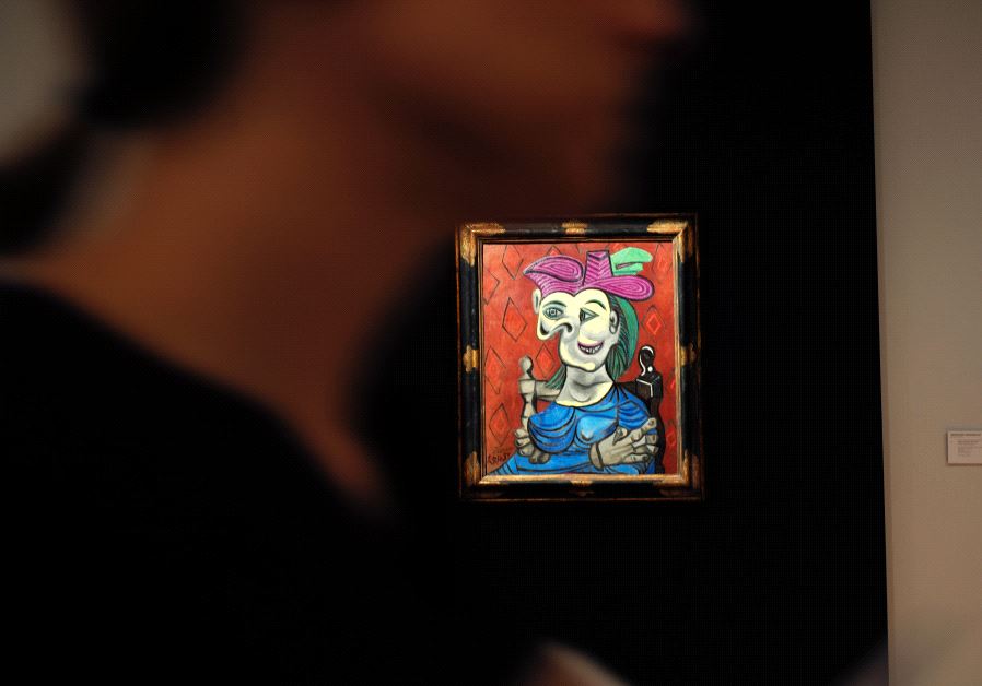 Visitors walk around Pablo Picasso's depiction of Dora Maar in "Femme assise, robe bleu", May 2017.