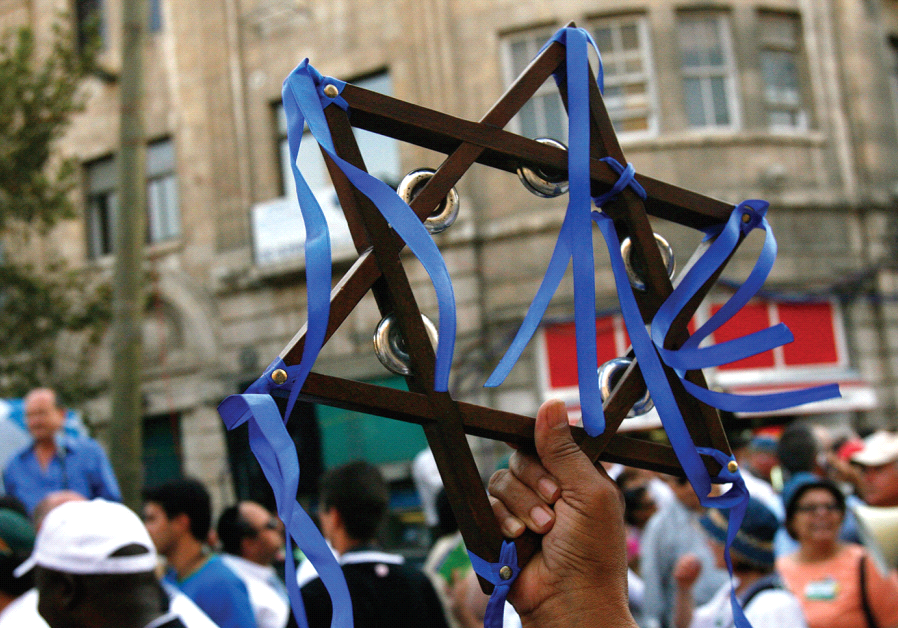 A christian reveler holds a Star of David while marching in an annual parade during Sukkot in Jerusalem in 2007