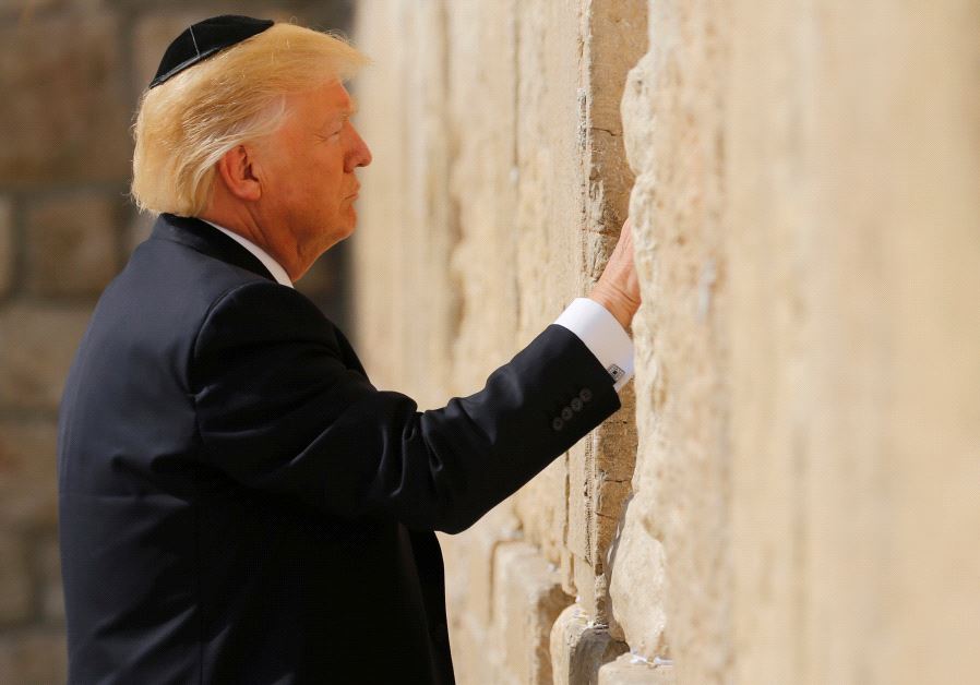 US President Donald Trump places a note in the stones of the Western Wall, Judaism's holiest prayer site, in Jerusalem's Old City May 22, 2017.