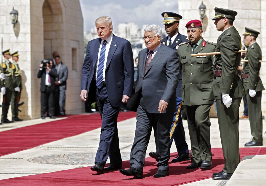 US President Donald Trump (L) and Palestinian leader Mahmud Abbas (2nd L) review the honour guard at the presidential palace in the West Bank city of Bethlehem on May 23, 2017