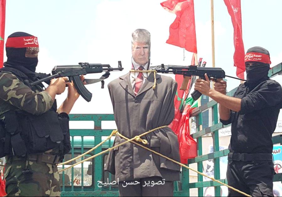 Armed men point machine guns at effigy of Donald Trump in Gaza protest, May 23 2017.