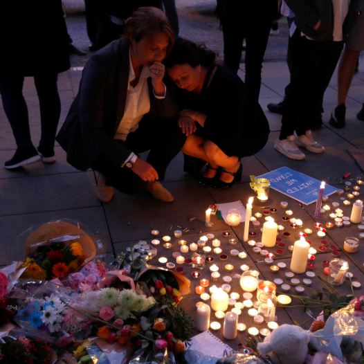 People pay their respects to the victims of the deadly suicide bombing in Manchester that took place during an Ariana Grande concert. 