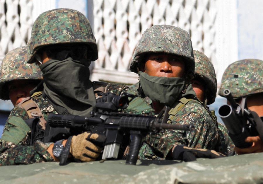 Members of Philippine Marines are pictured aboard a vehicle as more soldiers reinforce to fight the Maute group in Marawi City in southern Philippines May 29, 2017