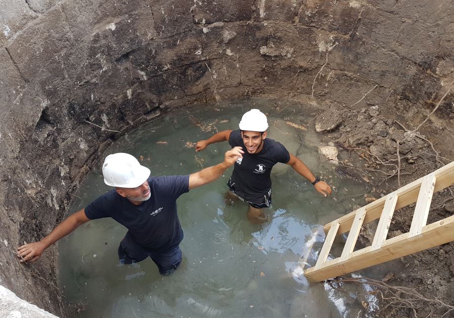 Israel Antiquities Authority guide Naftali Aizik and apprentice Faran Assaf Ramati work in the well