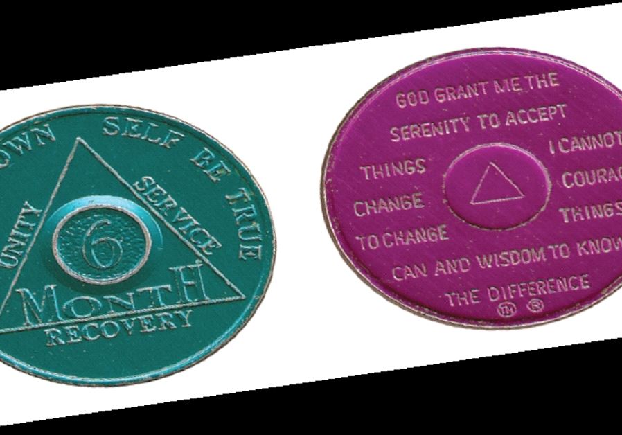 Sobriety chip given given to Al-Anon or other 12-step group members to denote specified lengths of sobriety; on the back is the Serenity Prayer. Here, green is for six months of sobriety; purple is for nine months