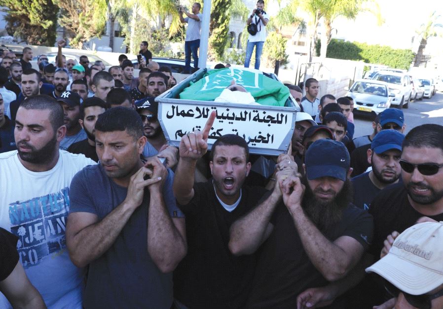 MOURNERS CARRY the body of Muhammad Taha at his funeral in Kafr Kasim, in the Triangle area east of Kfar Saba. Mayor Adel Badir accused police of routinely harassing people in the street.