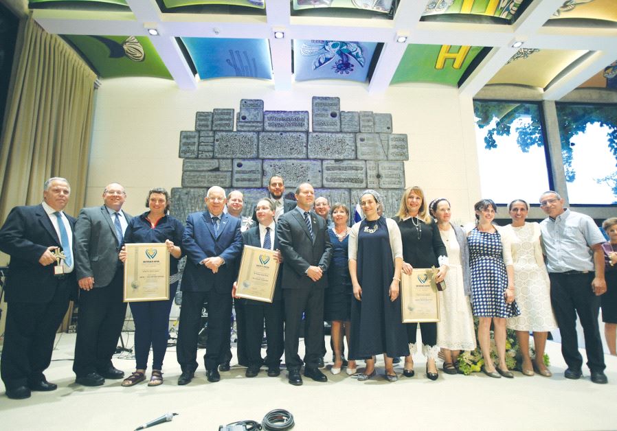 PRESIDENT REUVEN RIVLIN and Mayor Nir Barkat pose with the Jerusalem Unity Prize winners yesterday