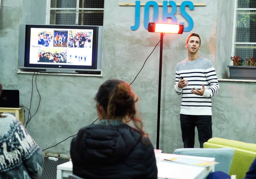 Noam Mordechay, co-chairman of an alumni group of a Boston-based Israeli- Palestinian startup incubator, speaks at a Jerusalem event
