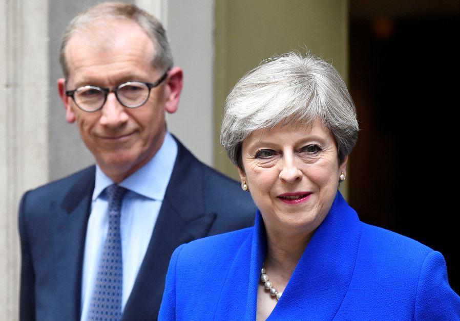 Britain's Prime Minister Theresa May leaves 10 Downing Street with her husband Philip to travel to Buckingham Palace to ask the Queen's permission to form a minority government, in London, June 9, 2017.