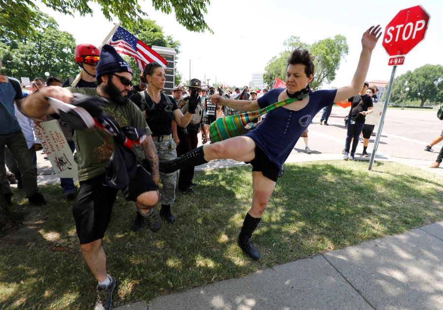 Anti-sharia protesters scuffle with counter demonstrators and members of the Minnesota State Patrol at the state capitol in St. Paul, Minnesota, US June 10, 2017