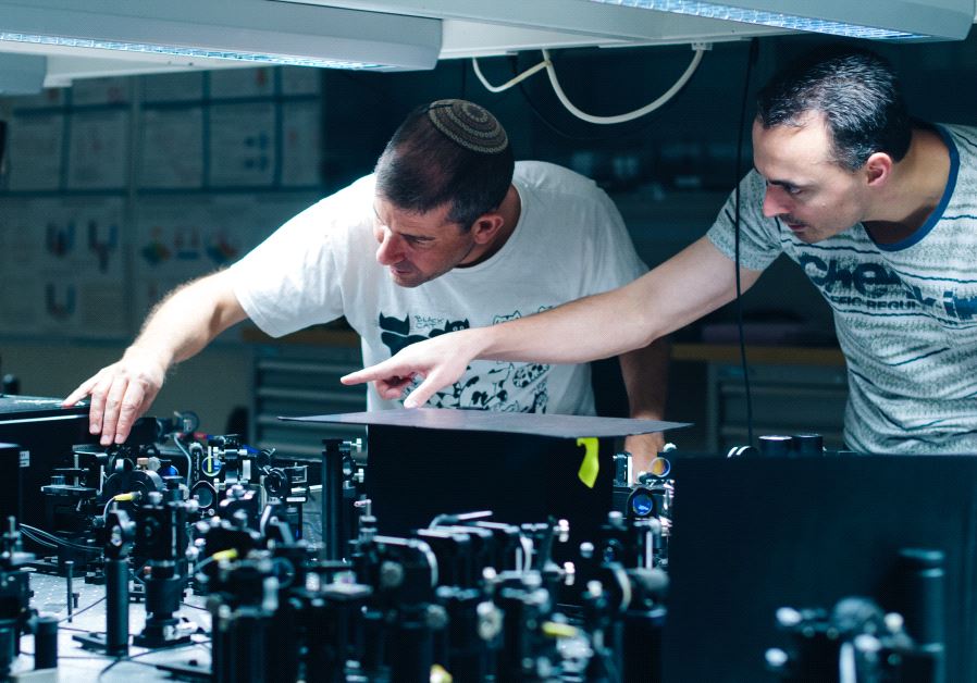 Prof. Hagai Eisenberg and graduate student Daniel Istrati study a single photon experiment at the Hebrew University's Quantum Information Science Center