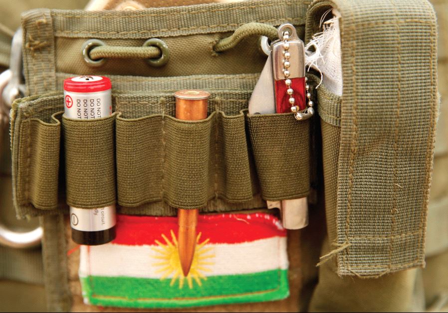 A BULLET and the Kurdistan flag are seen on a Peshmerga fighter’s vest during a battle with ISIS near Bashiqa, Iraq, last year.