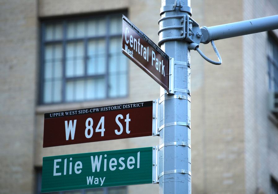 The street signs on the southwest corner of 84th Street and Central Park West are seen following a ceremony to permanently co-name the street with the late humanitarian and Nobel Peace Prize-winning name of Elie Wiesel, June 13, 2017 in New York.