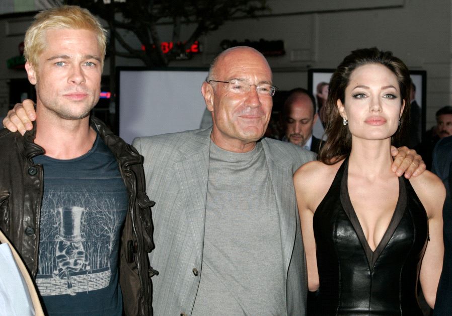 US actors Brad Pitt (L) and Angelina Jolie (R), stars of the new action film "Mr. & Mrs. Smith", pose with one of the film's producers, Arnon Milchan of New Regency at the film's premiere in Los Angeles June 7, 2005
