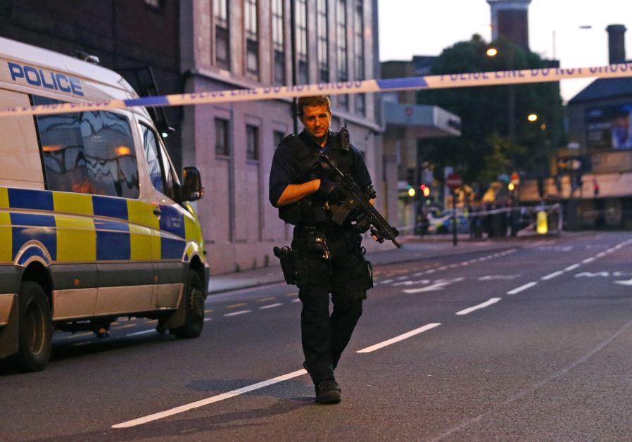 An armed police officer attends to the scene after a vehicle collided with pedestrians in the Finsbury Park neighborhood of North London, Britain June 19, 2017