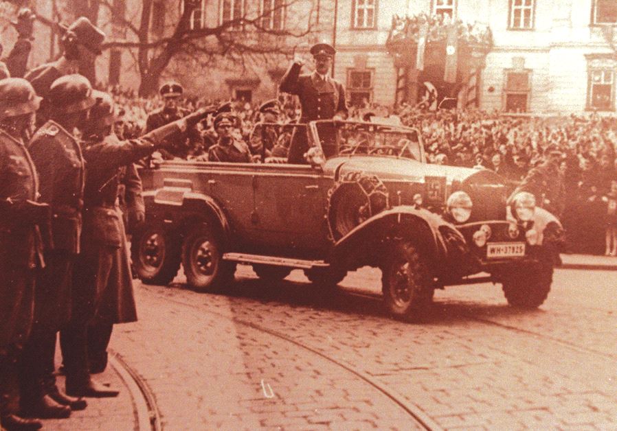 Adolf Hitler waves to crowds in his six-seater Mercedes car in this undated World War II file photo