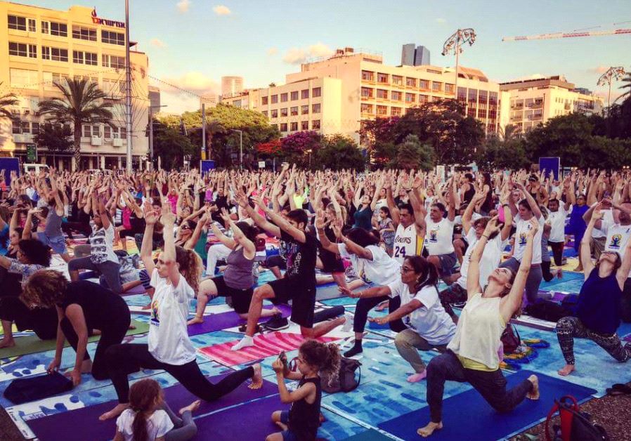 Participants take part in a communal yoga event in Tel Aviv to mark International Yoga Day, June 21 2017