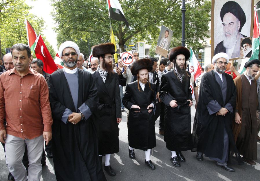 Muslim clerics and anti-Zionist orthodox Jews walk together during the annual al-Quds Day march in Berlin, Germany, July 11, 2015
