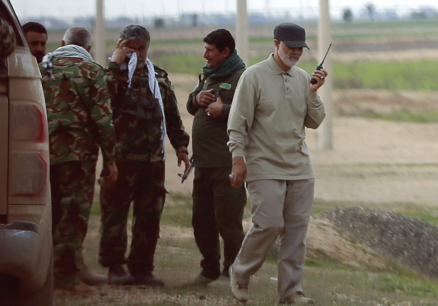 Qassem Soleimani uses a walkie-talkie on the frontline during offensive operations against Islamic State militants in the town of Tal Ksaiba, in Salahuddin province, in 2015