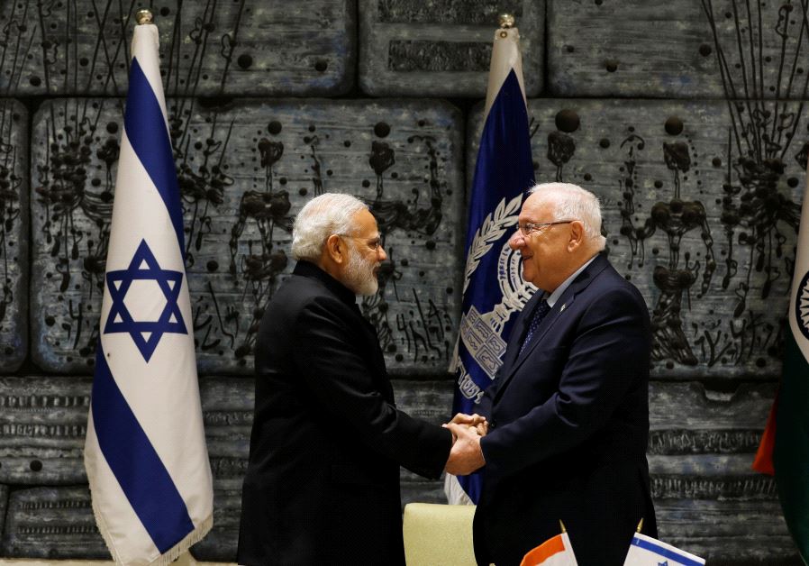 Indian Prime Minister Narendra Modi shakes hands with President Reuven Rivlin after signing a guest book before their meeting in Jerusalem July 5, 2017