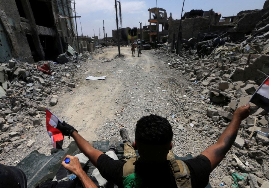 Members of the Emergency Response Division celebrate in the Old City of Mosul, Iraq July 8, 2017. 