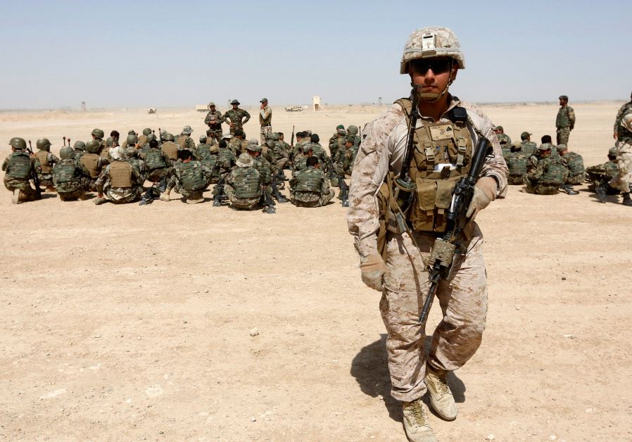 A US Marine walks near Afghan National Army (ANA) soldiers during training in Helmand province, Afghanistan, July 5, 2017.