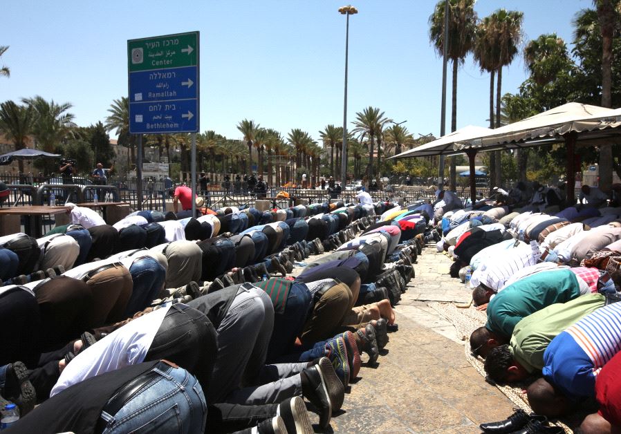 Muslims pray on the street outside the Old City