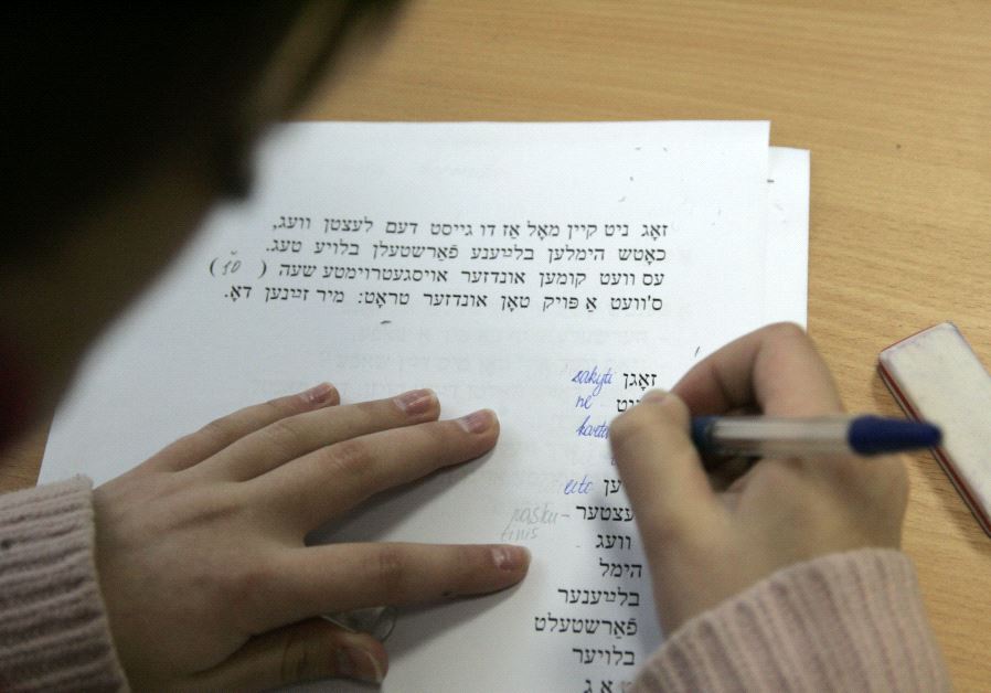A secondary school student learns Yiddish during a lesson of Jewish history and culture at Solomo Aleichemo Jewish school in Vilnius, Lithuania