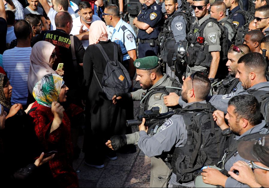 A Palestinian woman argues with an Israeli border policeman at the entrance to the compound known to Muslims as Noble Sanctuary and to Jews as Temple Mount, in Jerusalem's Old City 