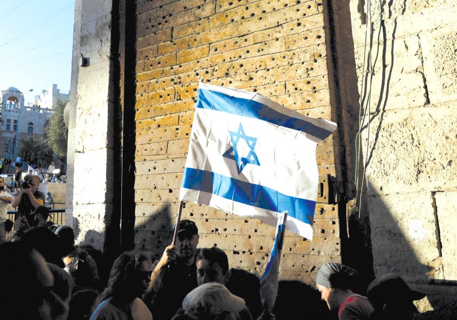 A man holds an Israeli flag during a protest