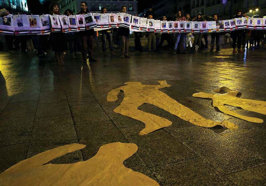 Demonstrators hold photographs of Palestinians they say have been victims of Israel’s military action during a gathering marking the UN’s International Day of Solidarity with the Palestinian People in Madrid, November 29, 2016