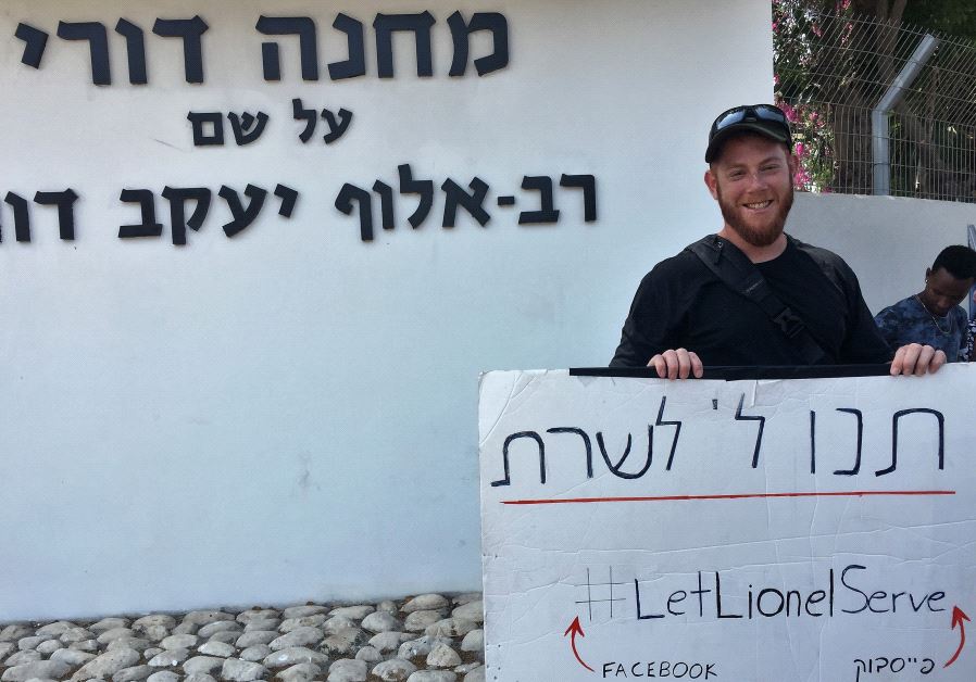 31 year old Lionel Kalles is standing outside the IDF induction center in Ramat Gan with a sign calling on the army to let him serve. 