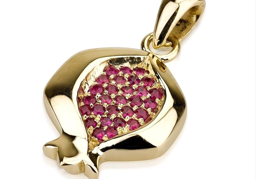 Gold pomegranate pendant with red ruby gemstones.